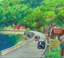 [ID: a busy road beside a lake with trees in the background]