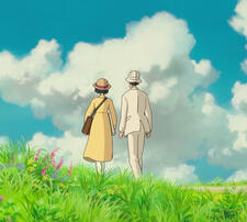 [ID: two people holding hands on a hill infront of a blue sky]